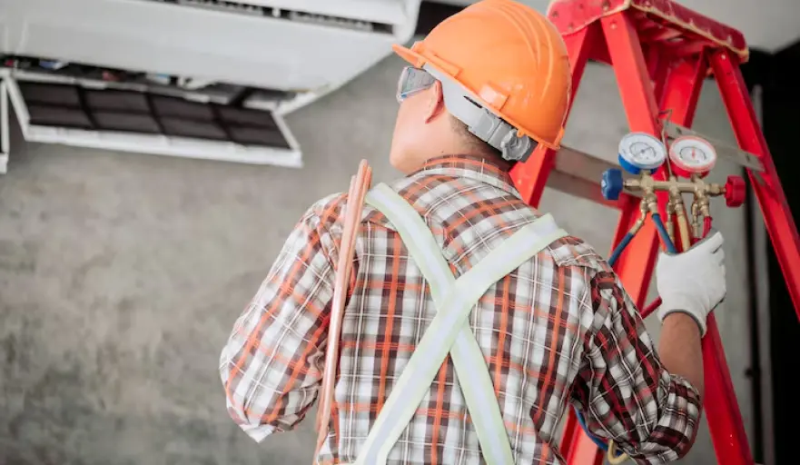 Technician servicing an air conditioner
