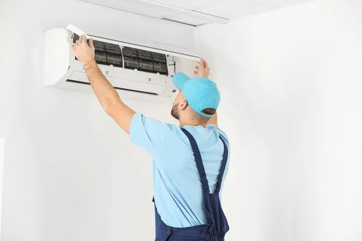 Qualified technician installing an air-conditioning unit